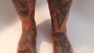 Tattooed blonde MILF washes her feet