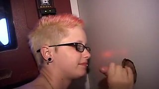 Punk rock babe with glasses kneels down and worships gloryhole cocks