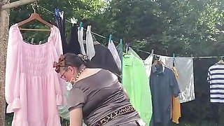 In an outfit with a charcoal colored ruffled dress to gather the laundry.