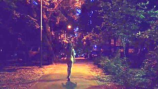 Naked woman walking on the city street in the early