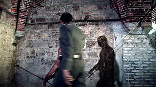 Hanging at the Wall with Her Legs Spread Wide Apart the Female Prisoner Is Made Hot by Lashes