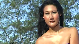 Asian babes getting naked on the beach