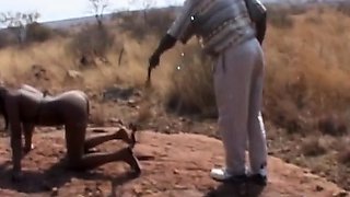 Rough outdoor spanking and tormenting with busty African