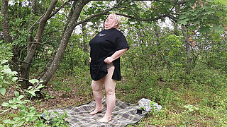 Stepmom undressed in a public park and masturbates her big pussy