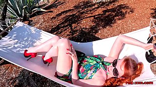 Red XXX stuffs her pussy with a toy in the hammock