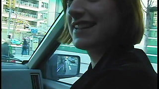 Commuter redhead carpools with creep who debases her in car in city traffic