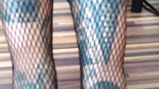 Tattooed lady in fishnet pantyhose